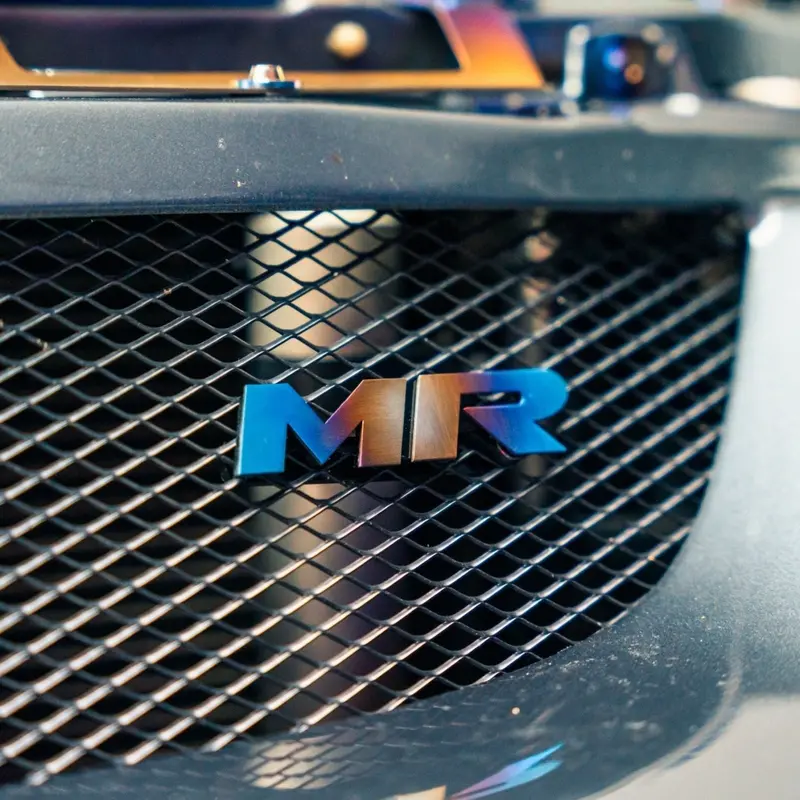 Jdc Titanium "Mr" Front Grill Badge | Mitsubishi Evo 8/9 4